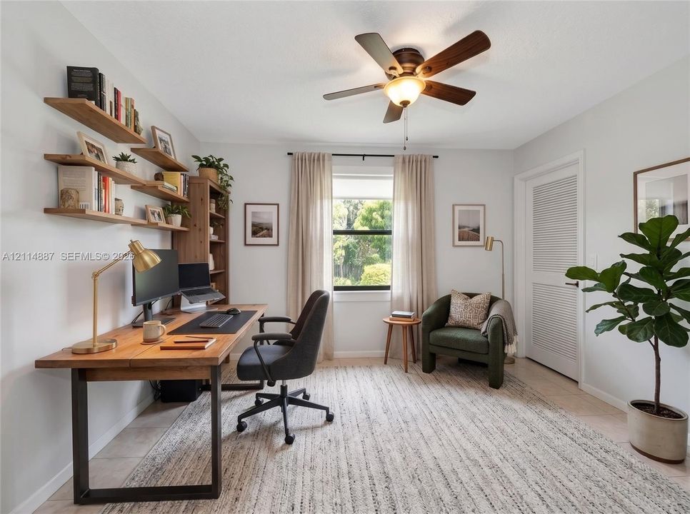 Wall-mounted natural wood shelving, ceiling fan with integrated lighting, and louvered door