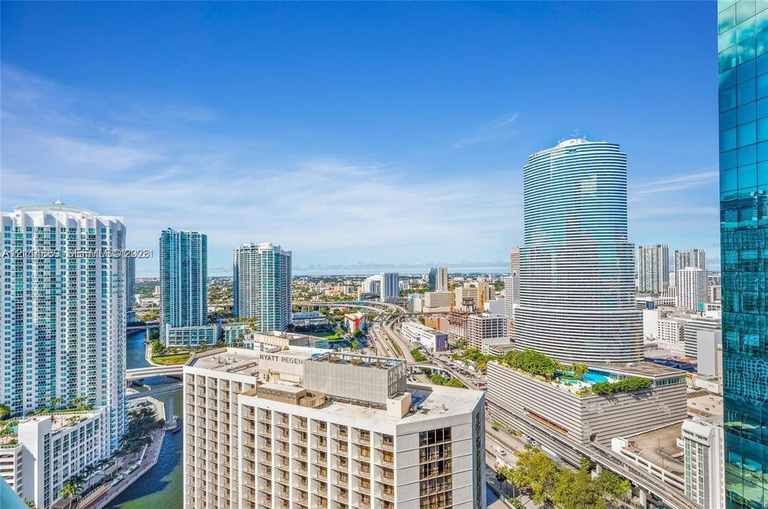 High-rise urban landscape featuring glass curtain wall buildings, concrete mid-rise structures, and elevated roadway infrastructure
