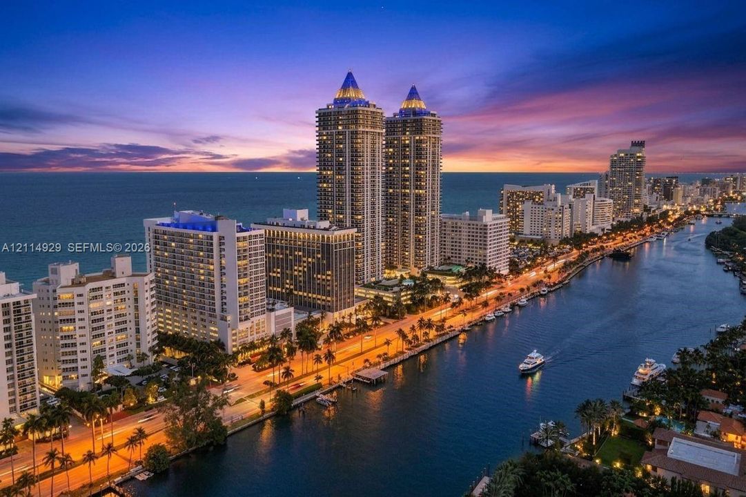 High-rise towers situated along a coastal waterway featuring marina access and panoramic waterfront scenery