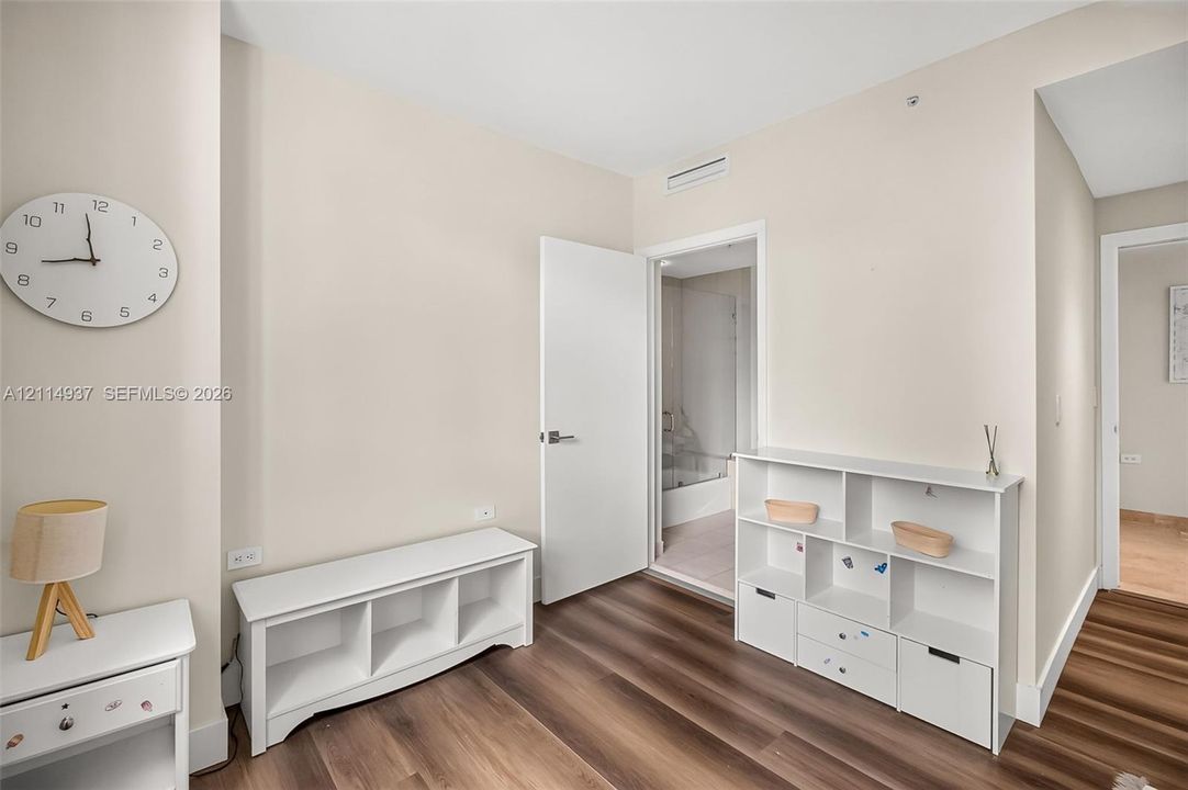 Neutral-toned walls and wood-finish flooring throughout