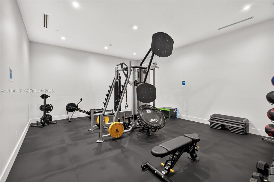 Flexible room featuring recessed ceiling lighting and durable rubber flooring