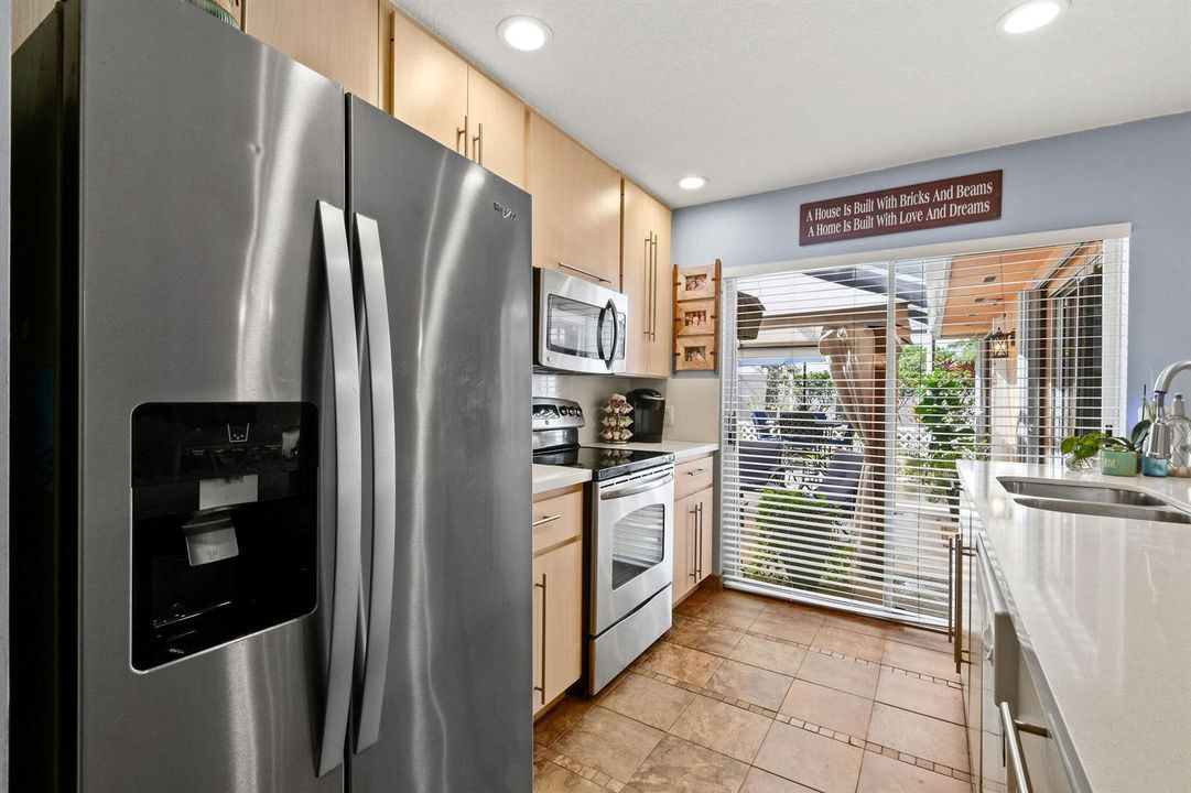 Kitchen - quartz counter SS appliances