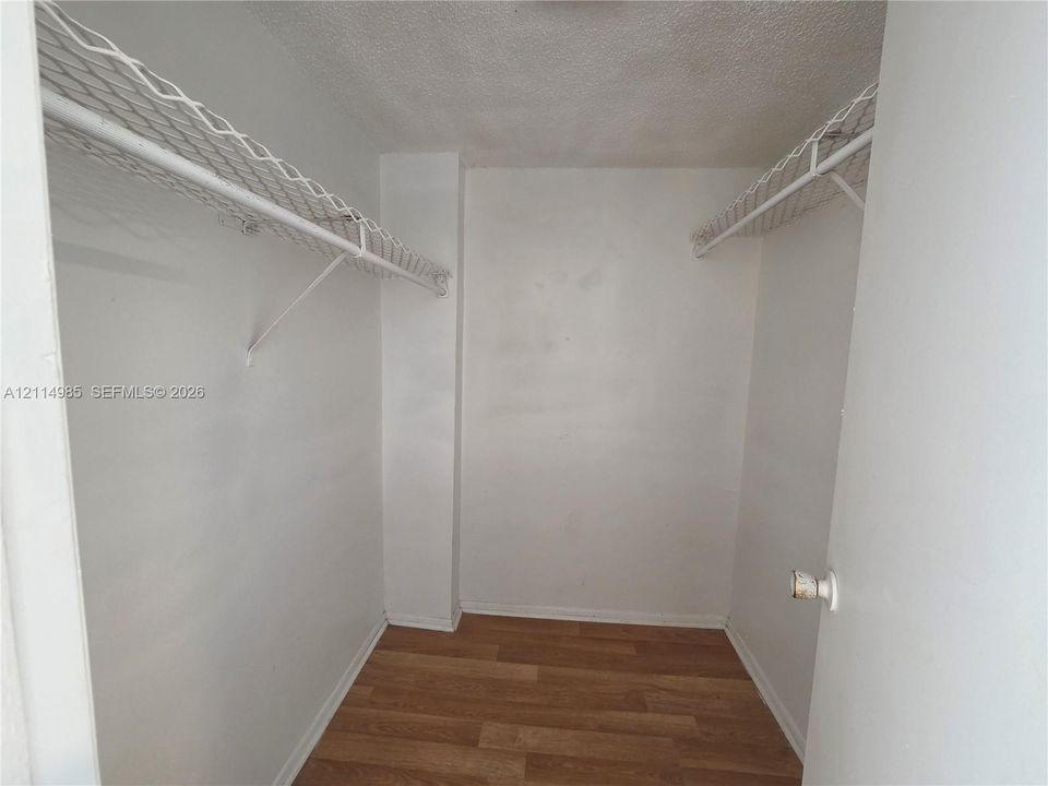 Storage afeaturing wood-finish flooring and dual overhead wire shelving units