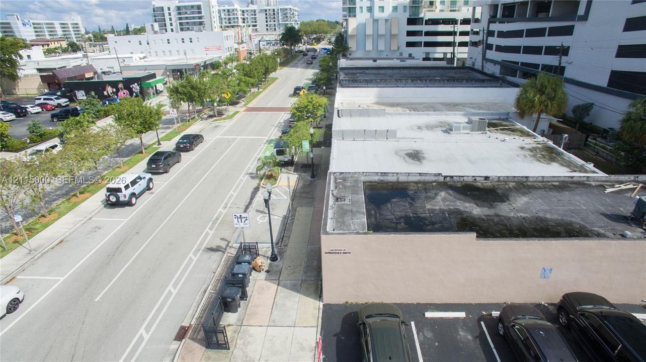 Commercial property with flat-roof structure, asphalt-paved surface parking, and street-front accessibility