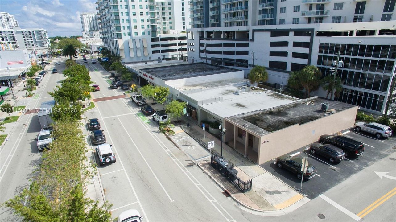 Commercial property featuring a flat-roof structure with exterior masonry walls and a dedicated surface parking area