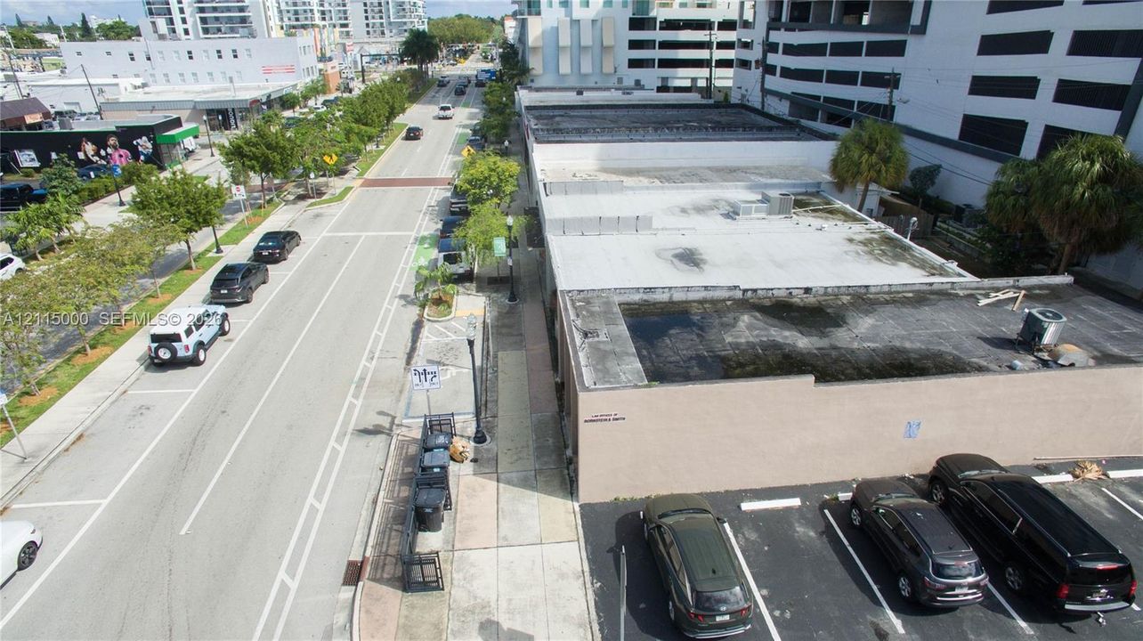 Commercial building with a flat roof, concrete exterior, and a dedicated surface parking area