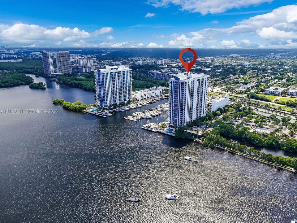 High-rise residential tower situated on a waterfront parcel featuring deep-water boat slips and direct canal access