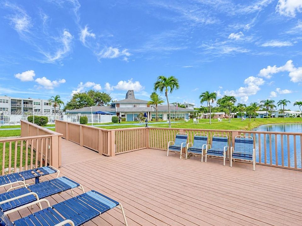 Waterfront wooden deck featuring perimeter fencing and open-air space