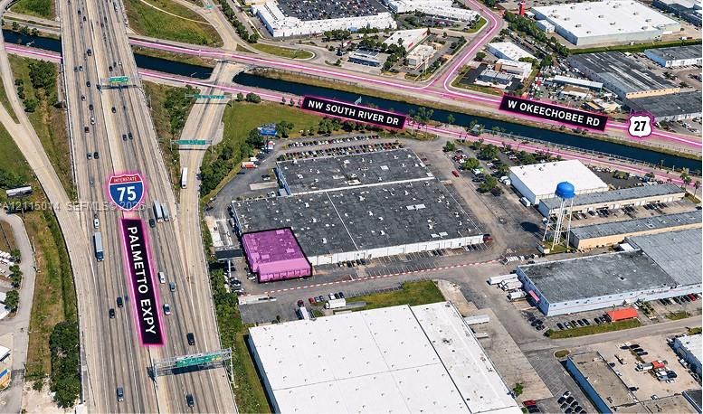 Industrial property featuring an expansive asphalt parking area, a multi-bay warehouse structure, and direct positioning near the junction of Interstate 75 and the Palmetto Expressway