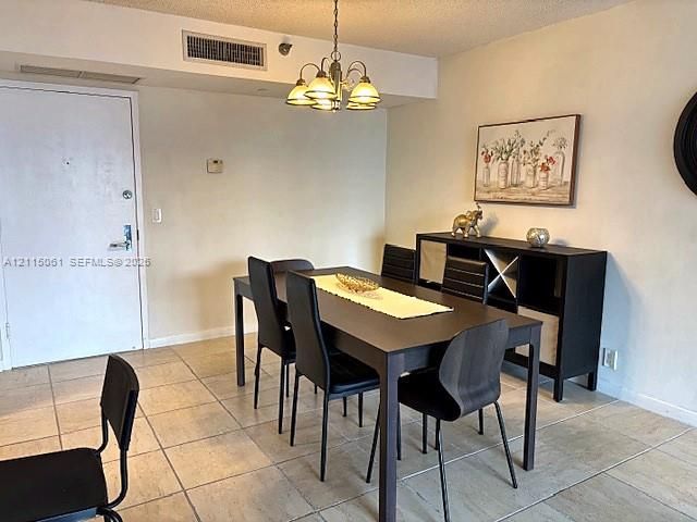 Neutral tile flooring and a multi-light metal chandelier