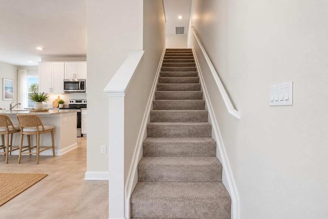 Bright Coastal Home Entryway and Stairca