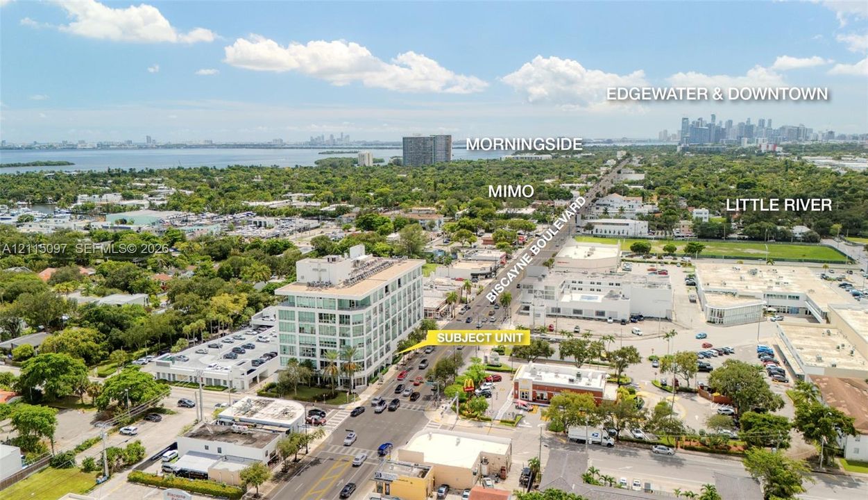 Aerial perspective highlighting the multi-story commercial building situated along Biscayne Boulevard, featuring prominent frontage and proximity to established neighborhoods and major urban centers