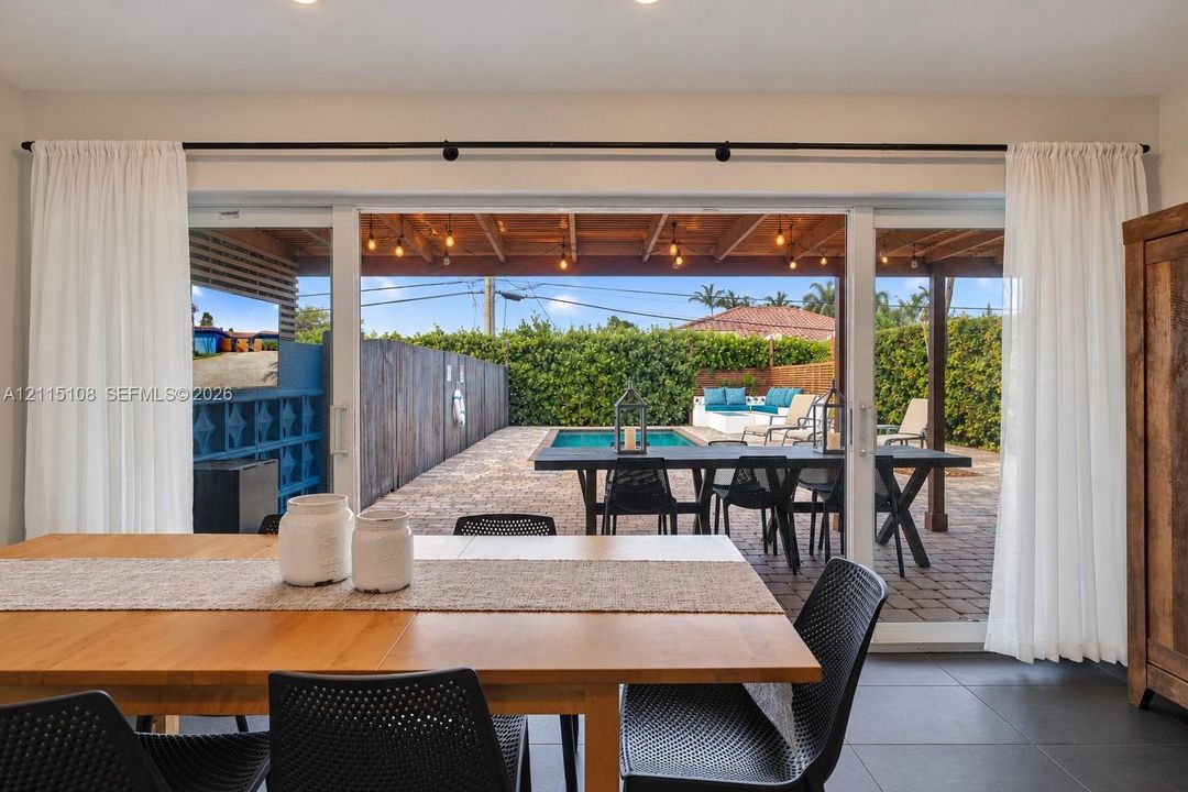 Large impact sliding glass door, covered patio with heated pool, and fully privacy  enclosure.