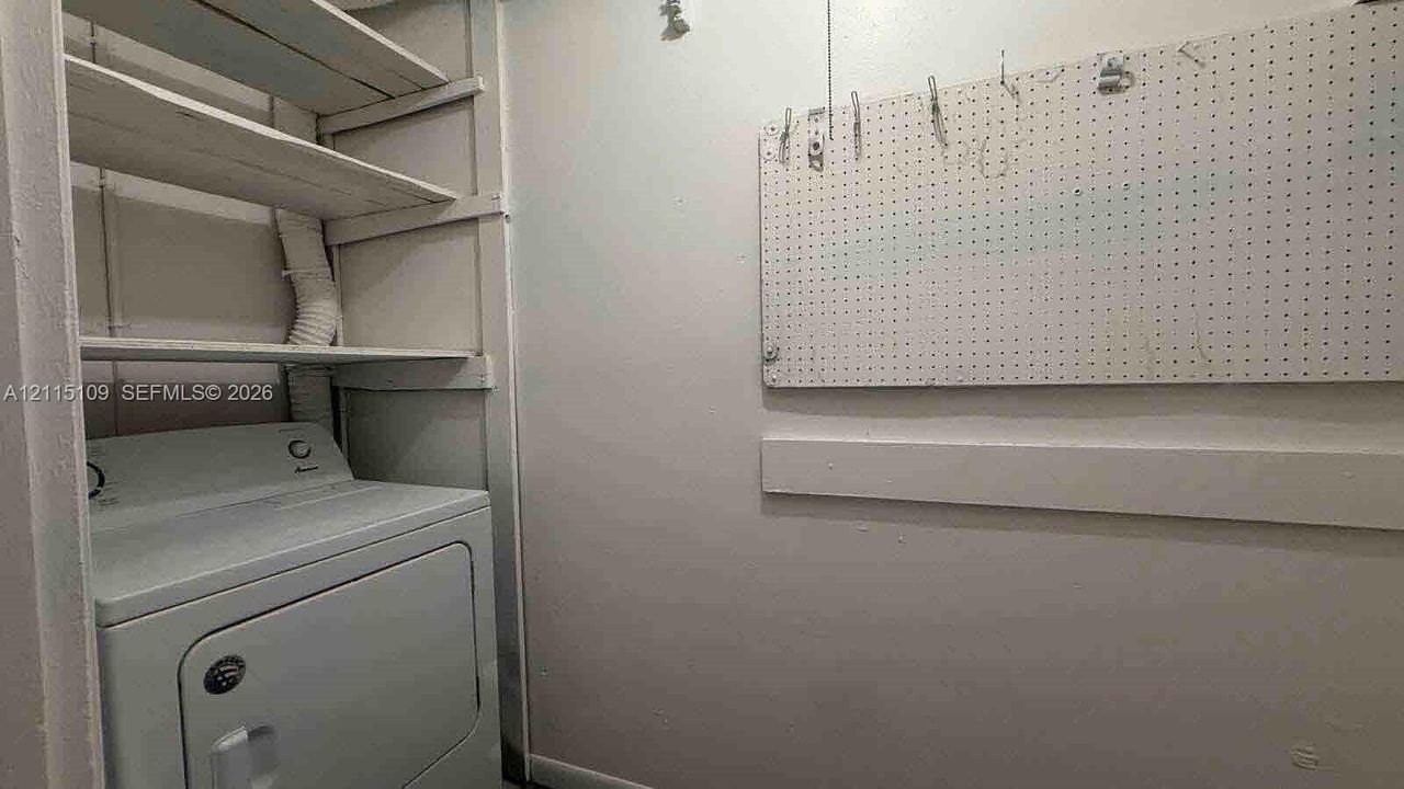 Built-in shelving unit, wall-mounted pegboard organization system, and dedicated appliance hookups