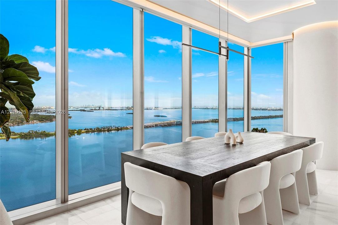 Floor-to-ceiling glass sliding doors, polished tile flooring, accent wall, and built-in flush-mount ceiling lighting