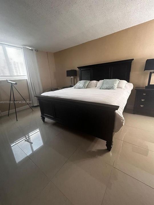 Large-format tile flooring and natural light from the expansive window