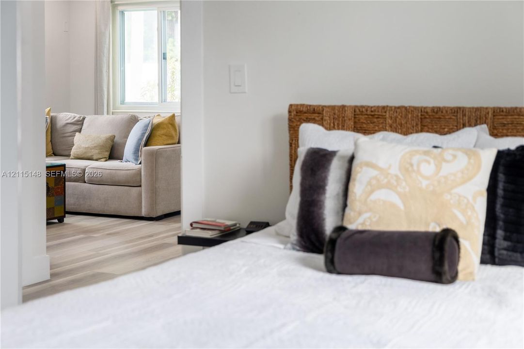 Neutral wall tones, light-finish wood flooring, and a sliding window