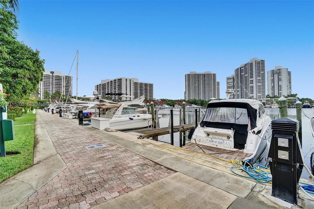 Deep-water marina featuring a paved stone walkway.