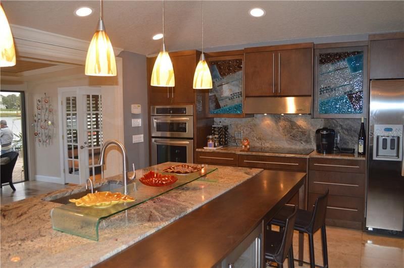 Custom glass cabinets, dual ovens, wine cooler, instant hot water, electric plugs in cabinets to hide appliances.