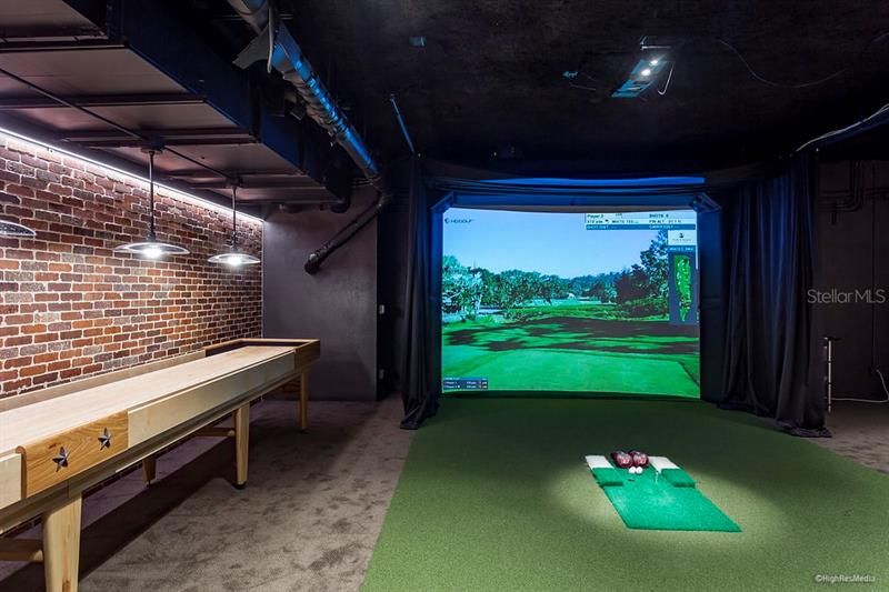 Game/media room with gaming tables, homes theater with surround sound, and golf simulation