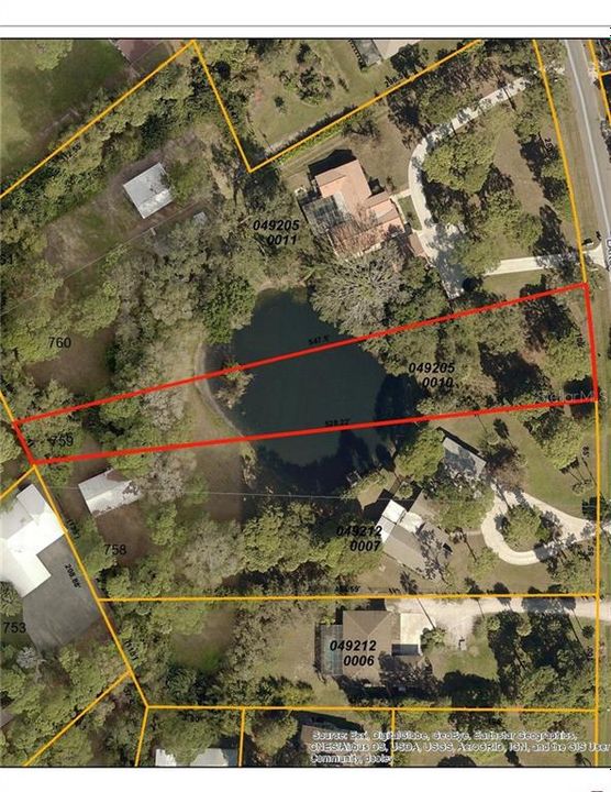 Front of lot to the right going across the pond and narrowing at the back of the lot.