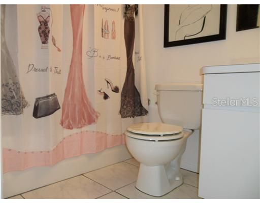 Bath1 - Bathroom has tub with shower, tile floors, and larger mirrored medicine cabinet