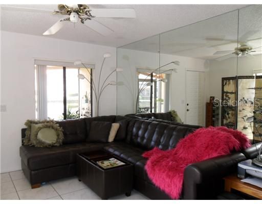 Living Room - Living room is bright with wall to wall mirrors and two windows that look out over water