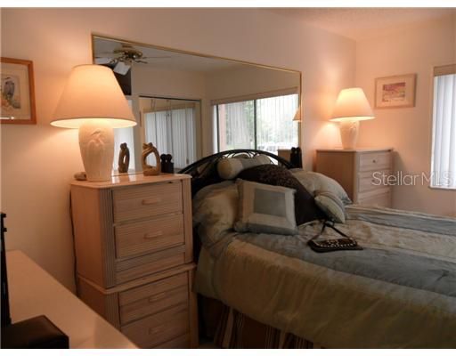 Bedroom 1 - Mirror accent brightens the room. Floor is tiled,