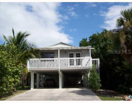 Exterior Front - 2 car carport, covered open deck, storage room