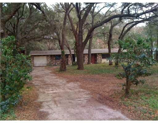 Exterior Front - Lots of privacy in this oak hammock. Ag zoning in Orange County, yet with one mile of the City of Apopka. Large 3 bedroom, two bath on well and septic, no sewew/water bills NO HOA, perfec for subcontractor or small business owner with equipment to store
