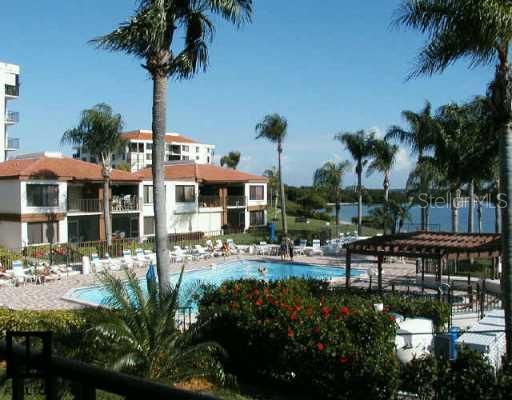 Exterior Front - Gorgeous tropical view from your balcony over looking the pool and bay.