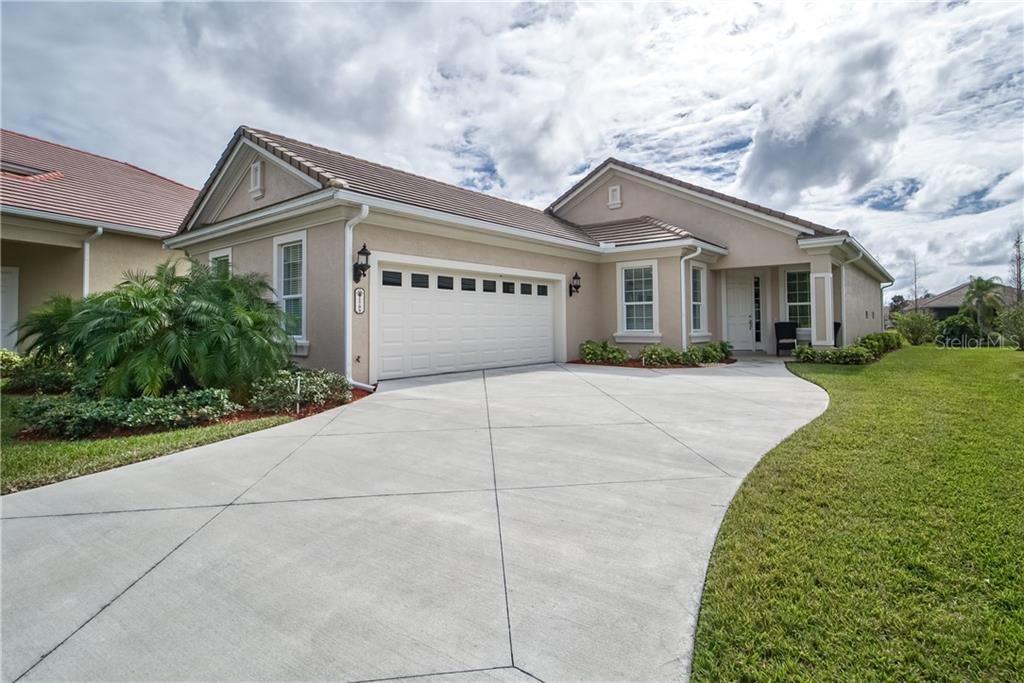Beautiful neutral exterior with extra long driveway and side entry garage