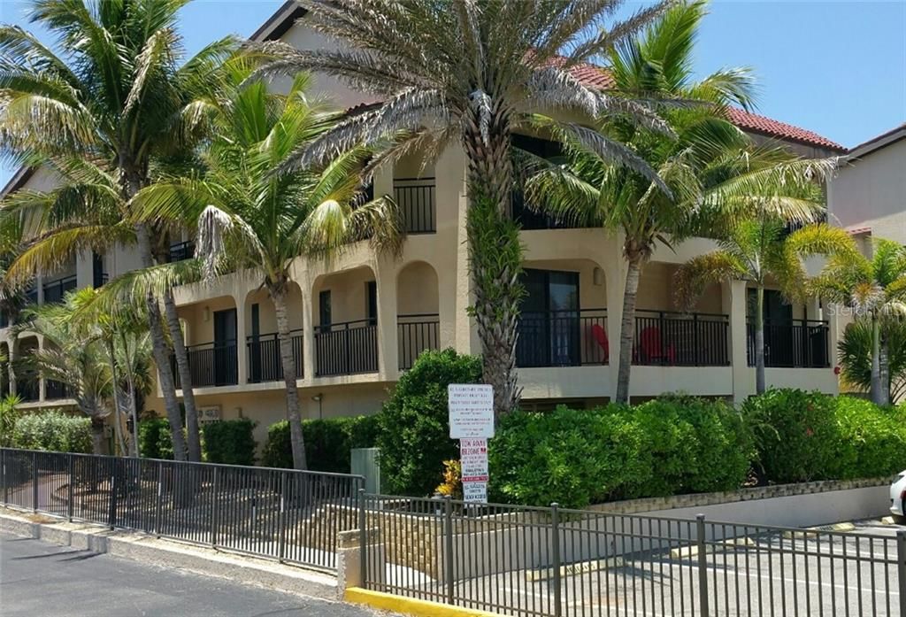 El Galeon by the Sea Building Front Exterior. Rental unit 601 located on first floor corner (in center of pic). Unit offers both southern and eastern balconies with sliders to each from inside unit. Notice red porch furniture on right-side balcony.