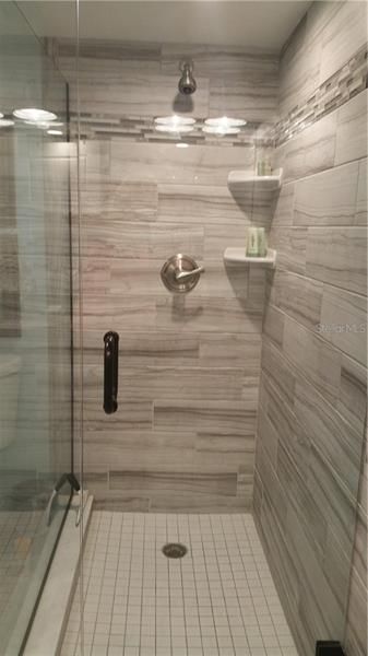 Convenient walk-in shower with glass door