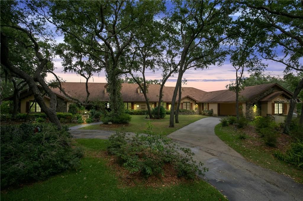 Beautiful tree lined entrance will lead you to this Stunning custom home on Lake Gary.