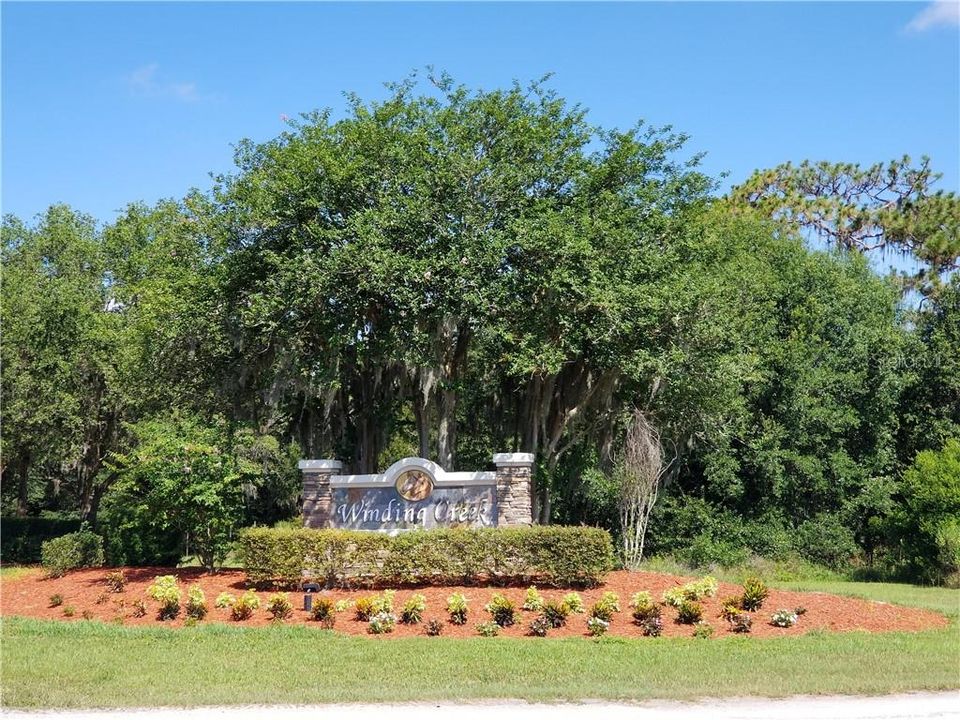 Beautiful Entryway to Winding Creek's quiet winding tree lined roads.