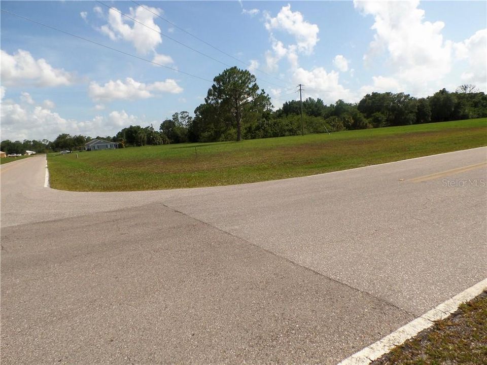Burnt Store Village corner lot with wooded at the  rear of lot +  across the street from the BS Village park offers Lake views with walking paths and a play ground !