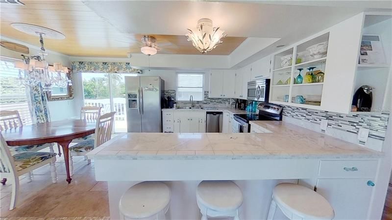 Luxury Kitchen With Granite Counters, Stainless Steel Appliances, Chandelier, Eat In Kitchen & Canal Views!