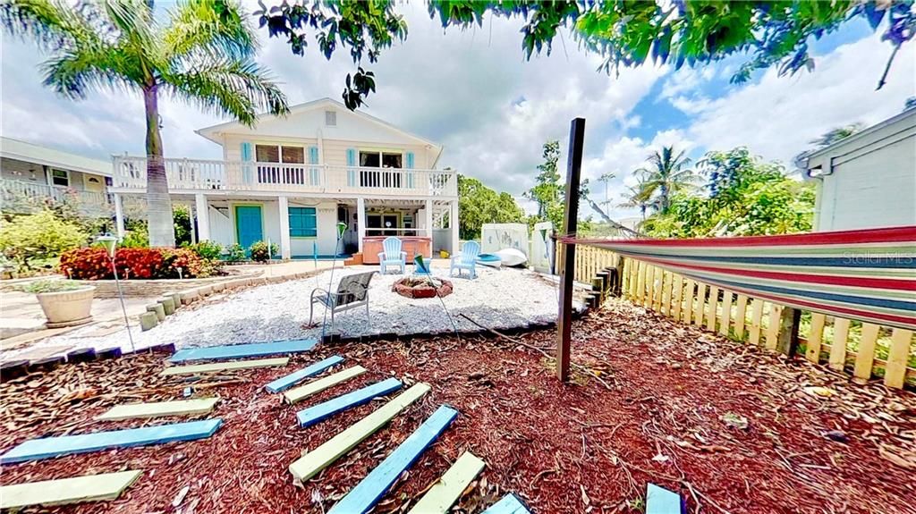 Private Backyard Canal Facing Oasis with Hammock, Fire Pit, Hot Tub, Covered Porch & Outdoor Shower