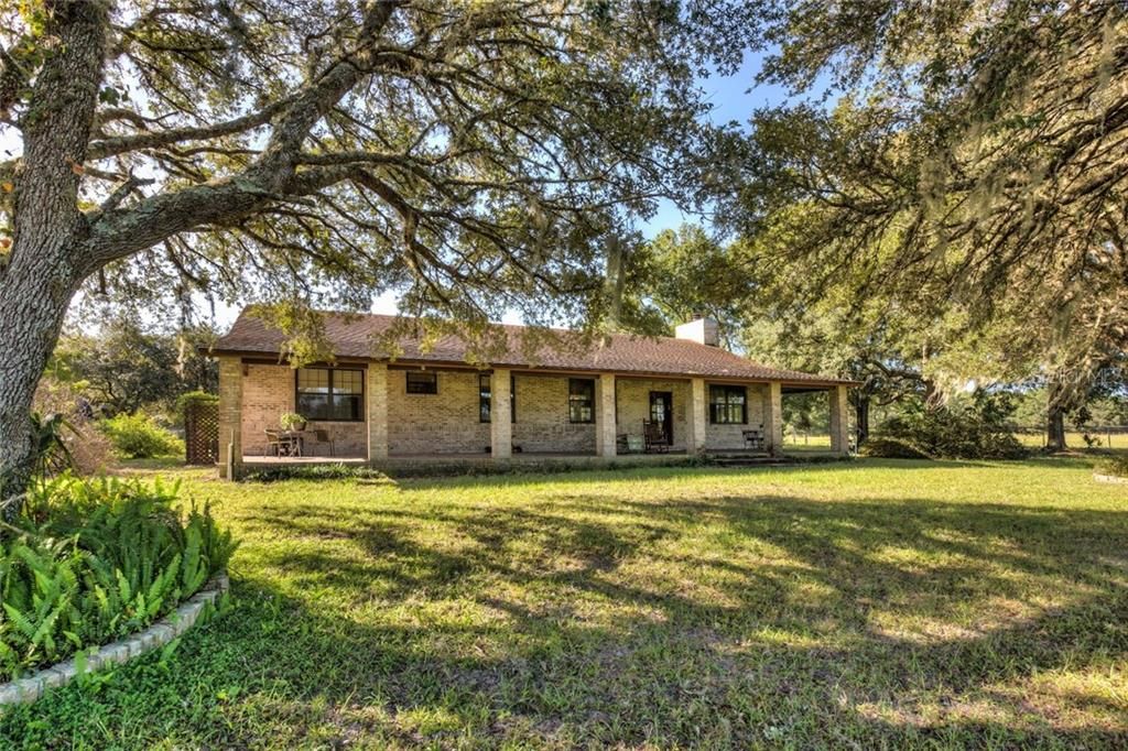 Ranch style low maintenance exterior brick on block construction. Front porch view of the majority of the property. The 200 acres is within the Wekiva Protection District "sending area" A-1-40 with conservation easement allowing one additional dwelling.