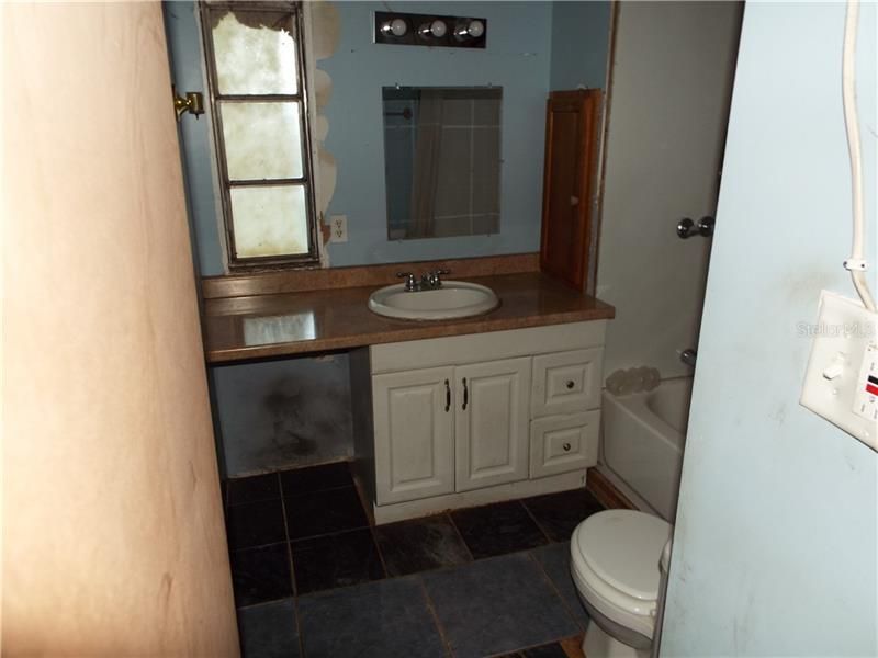 Clean bathroom with a new tub and shower. Imagine soaking in your own quite oasis.