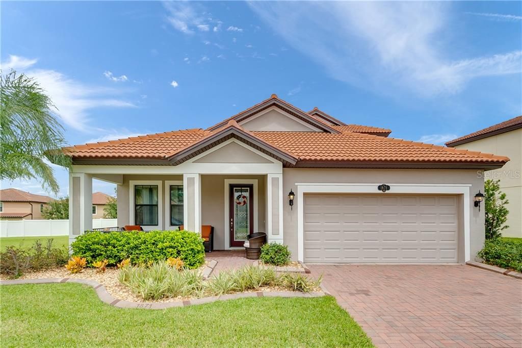 Tiled Roof, Pavers, Mature Landscaping, Concrete Stamped Curbing, Front Sitting Porch