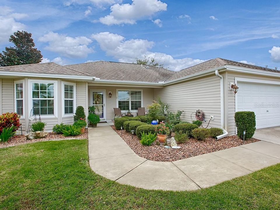 Colorful landscaping enhances the home's considerable curb appeal.