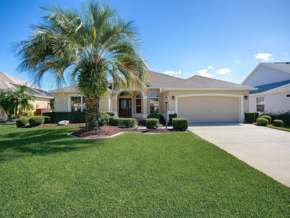 LUSH FRONT LAWN AND CURBED LANDSCAPING WELCOME YOU TO THIS BEAUTIFUL, STRETCHED GARDENIA DESIGNER HOME!