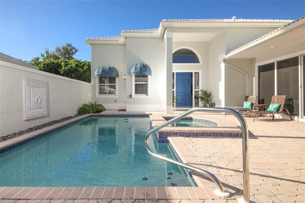 Large pool deck with privacy wall.  Master suite side door to pool