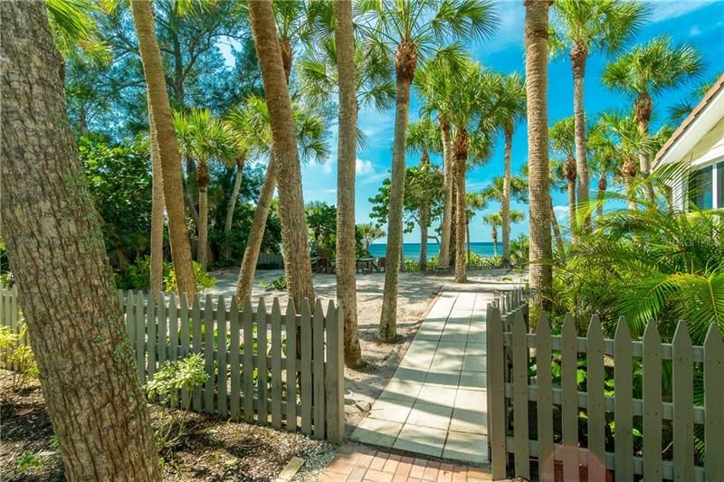 Gate to the Backyard with a Fire Pit, Hammock, and Deck All Overlooking the Gulf of Mexico.