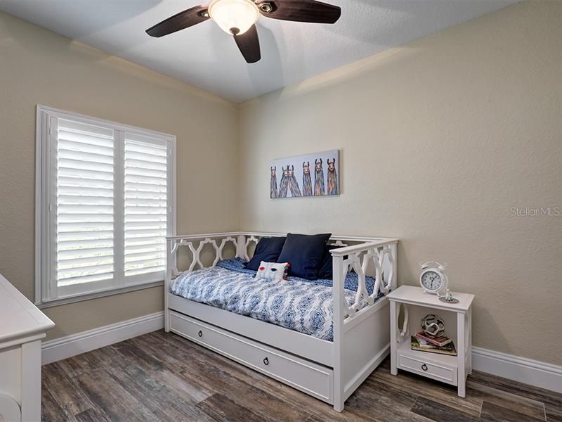 Bright and Sunny Bedroom #2.  Notice the elegant Plantation Shutters!