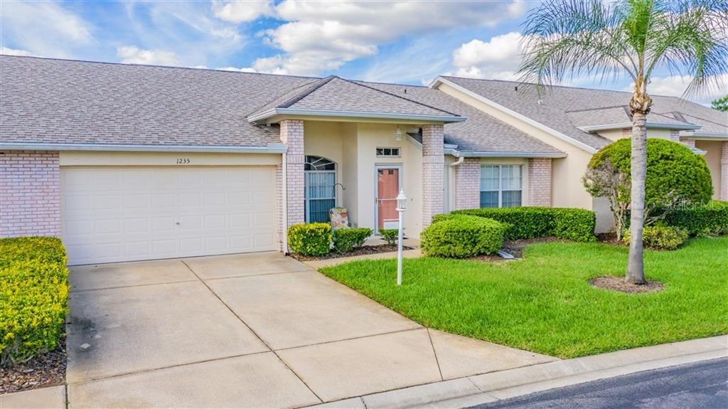 Covered front entry with landscaped front yard