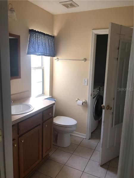 Master bathroom w/ view of laundry room