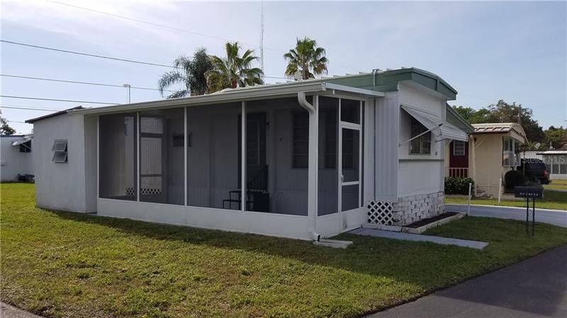 Street view of #48 at Countryside Estates, This 12 x 44 Mobile Home has a newly added lanai that is screened so you can enjoy the afternoon breezes or have your morning coffee and enjoy the sunrise!